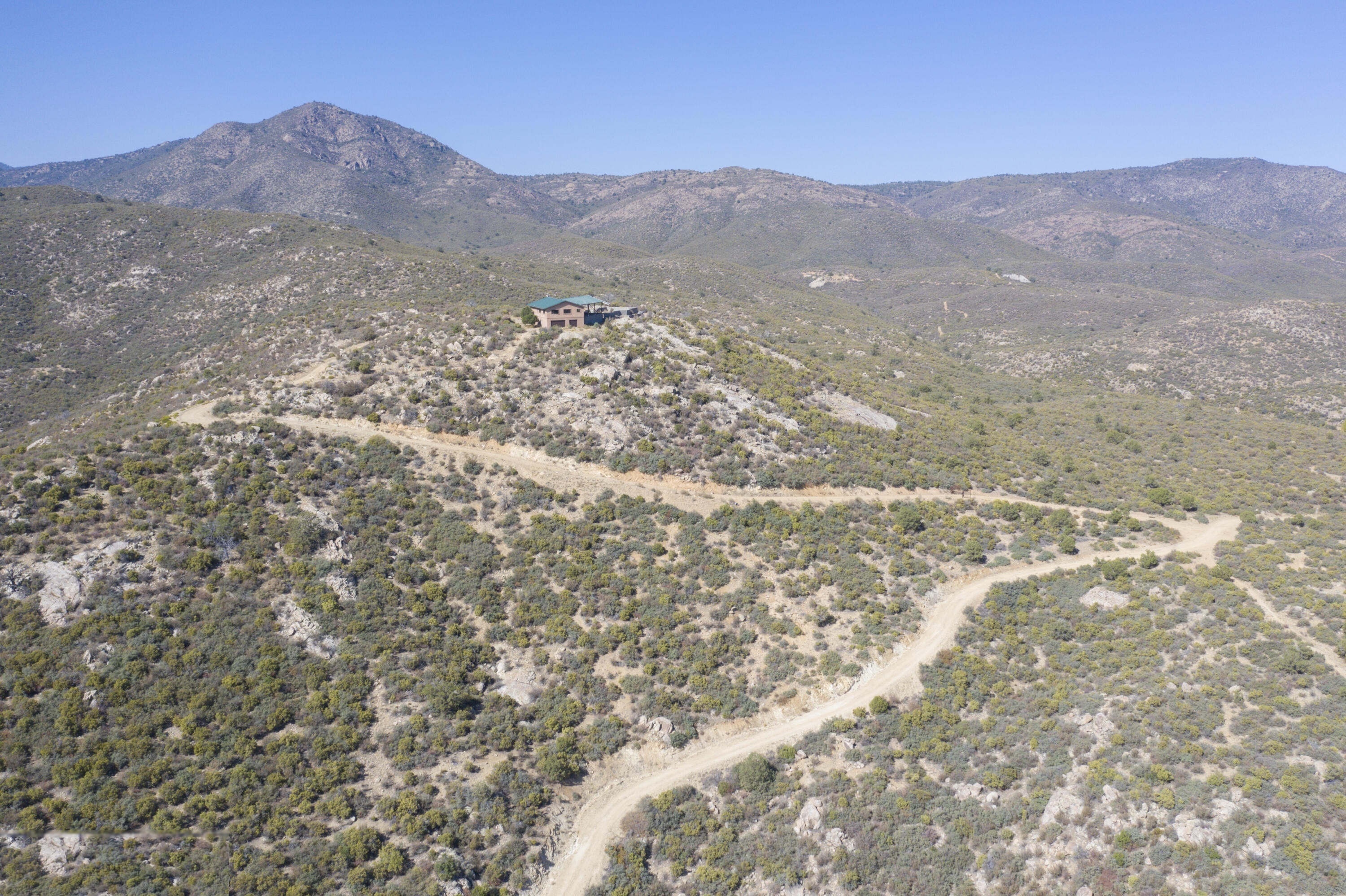 Home on ridgeline with winding driveway